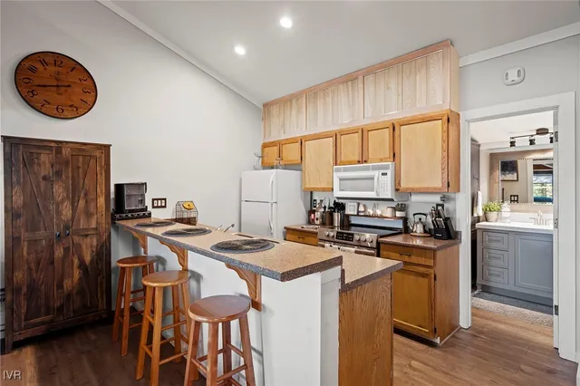 a kitchen with stainless steel appliances granite countertop a sink and a stove next to a window