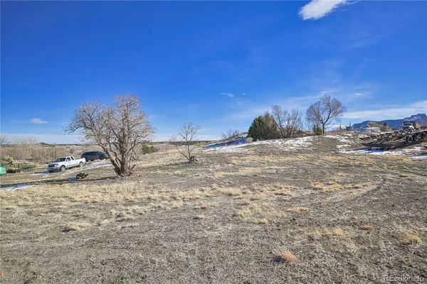 a view of a dirt road and a building