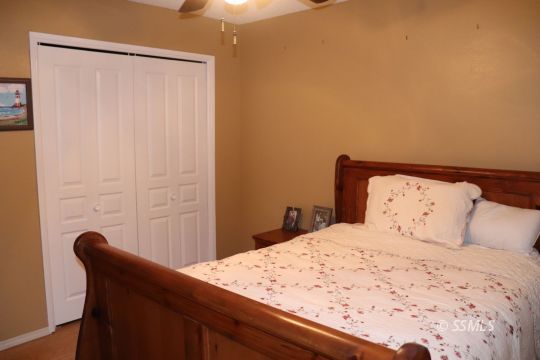1624 South Farragut Street Ridgecrest, CA 93555 - Photo 16 of 43 a bedroom with a bed and a chair