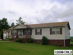 1269 Liberty Road Chester, SC 29706 - Photo 1 of 8 a front view of a house with a garden and yard