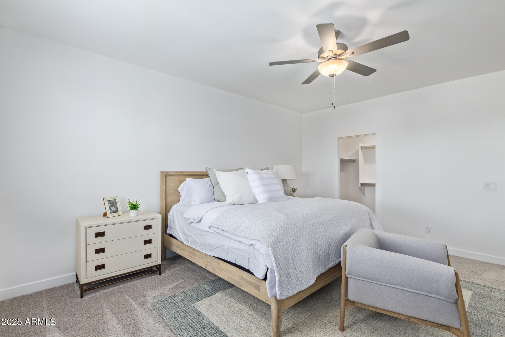3230 East Thomas Road, Unit 184 Mesa, AZ 85213 - Photo 17 of 30 a bedroom with a bed and a chandelier