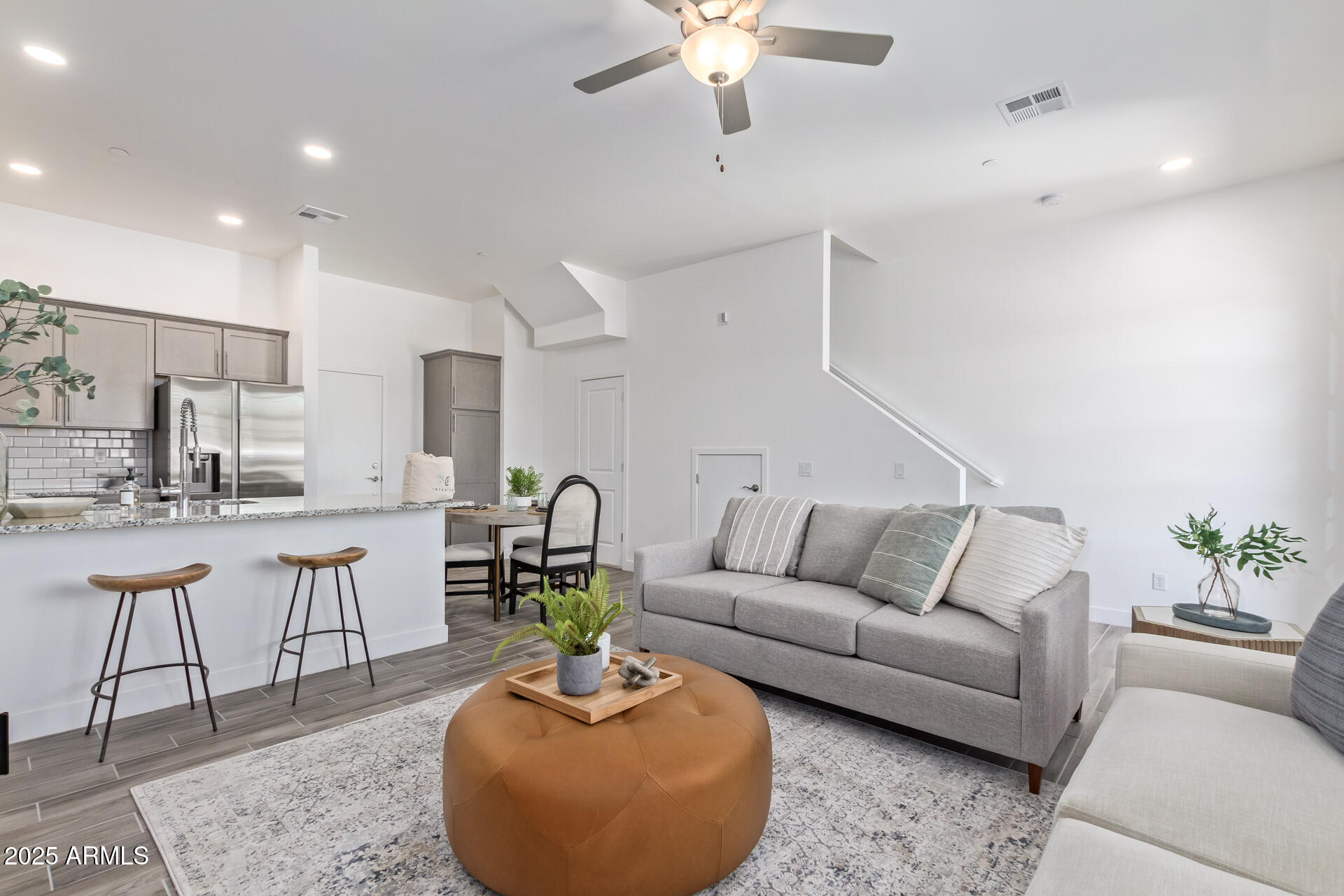 3230 East Thomas Road, Unit 184 Mesa, AZ 85213 - Photo 8 of 30 a living room with furniture a chandelier and kitchen view