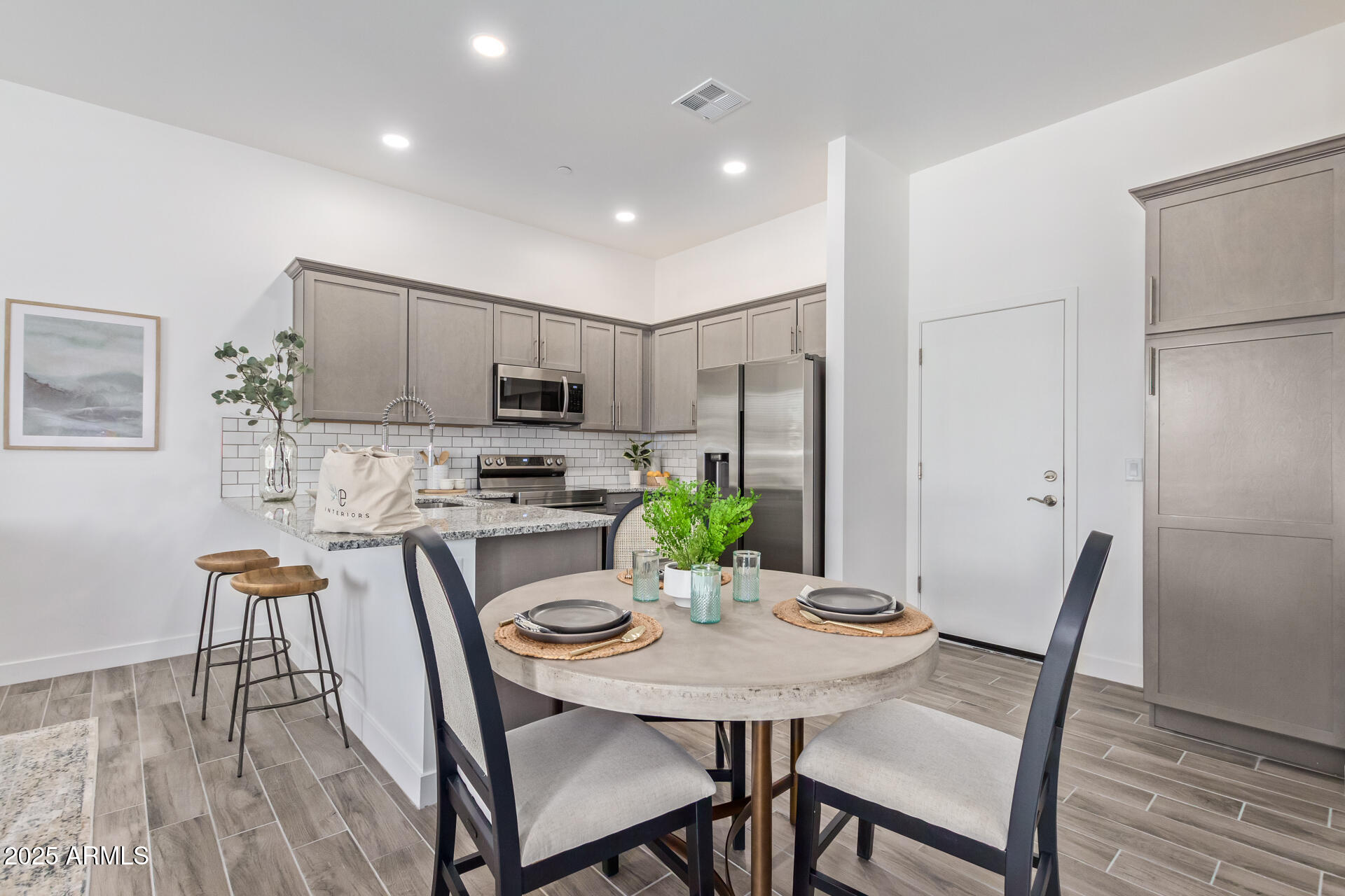 3230 East Thomas Road, Unit 184 Mesa, AZ 85213 - Photo 9 of 30 a view of a dining room with furniture and wooden floor