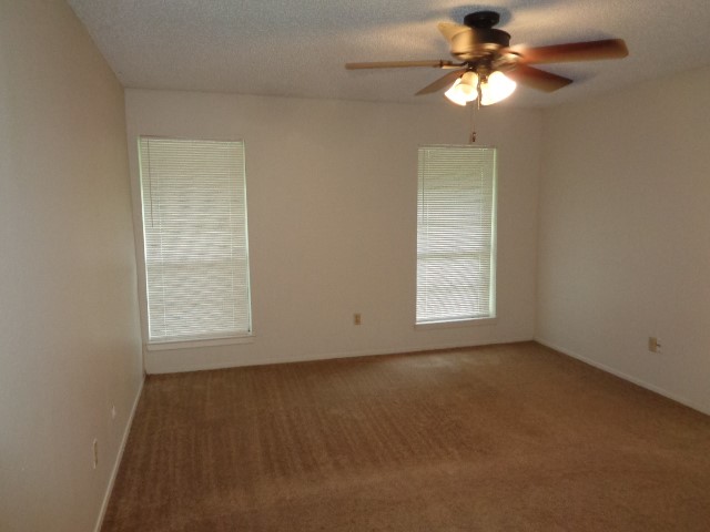 9530 Magnolia Ridge Drive Houston, TX 77070 - Photo 7 of 20 an empty room with a window and a fan