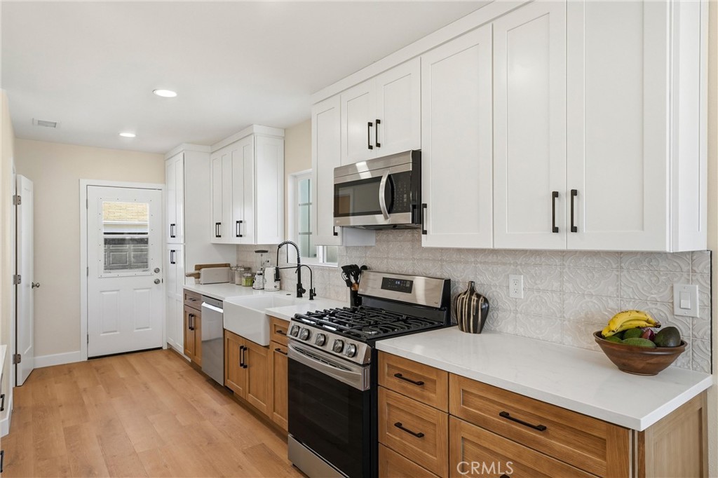 329 Catalpa Avenue Brea, CA 92821 - Photo 9 of 27 Quartz countertops, recessed lighting, LVP flooring, and large farm house kitchen sink!