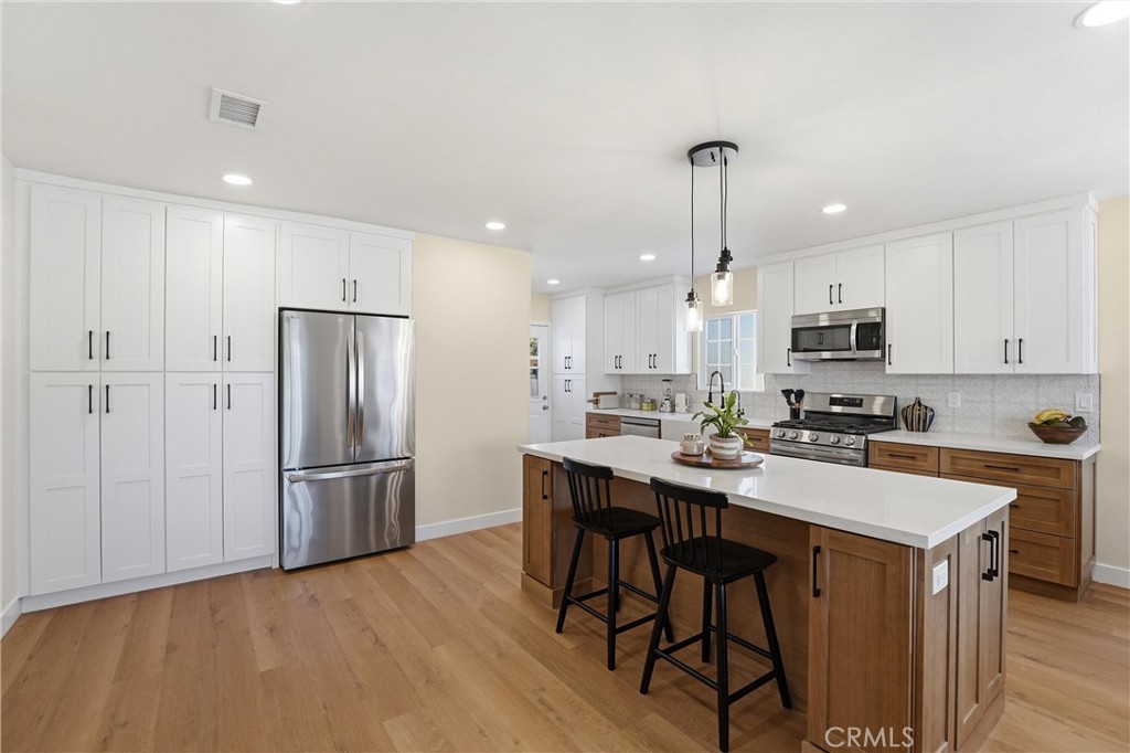 329 Catalpa Avenue Brea, CA 92821 - Photo 5 of 27 Built-in cabinetry with soft-close doors and drawers, large center island, new stainless steel appliances, and lots of natural light!