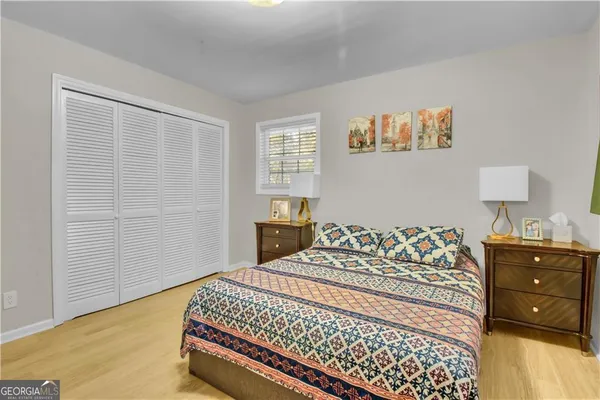 a bedroom with a bed and wooden floor