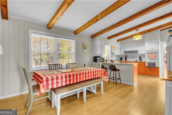 a dining room with a wooden table and chairs