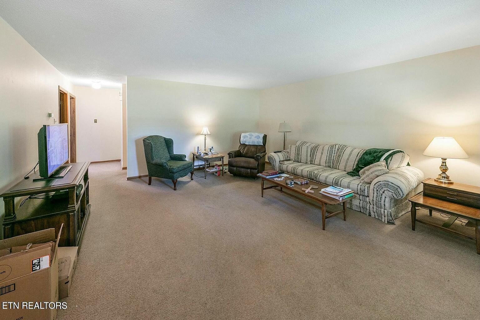 714 Broome Road Northwest, Unit B Knoxville, TN 37909 - Photo 4 of 10 a living room with furniture and a flat screen tv