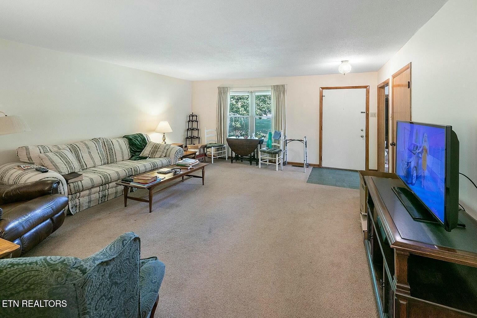 714 Broome Road Northwest, Unit B Knoxville, TN 37909 - Photo 6 of 10 a living room with furniture a window and a flat screen tv