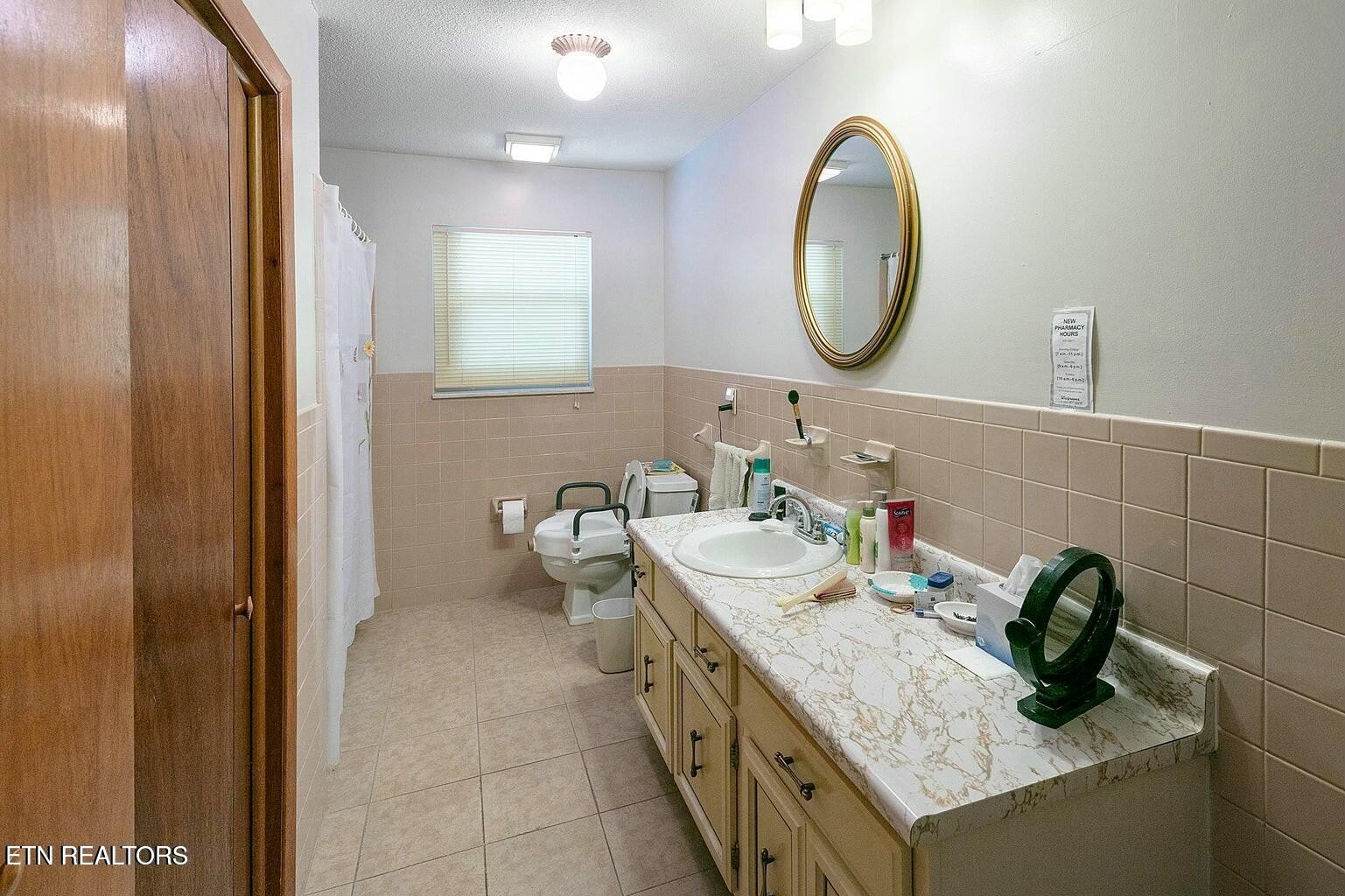 714 Broome Road Northwest, Unit B Knoxville, TN 37909 - Photo 7 of 10 a bathroom with a granite countertop double vanity and a mirror