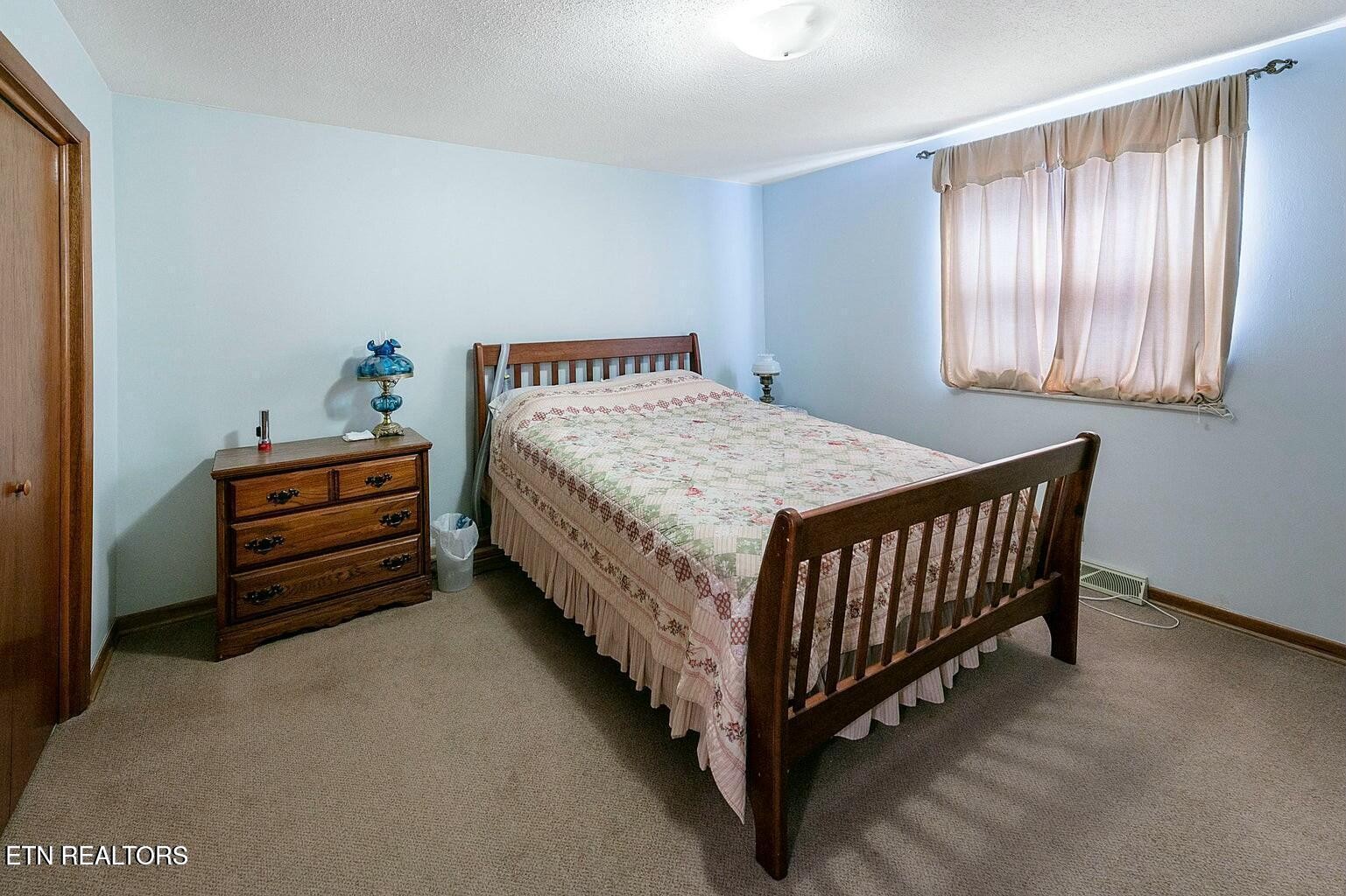 714 Broome Road Northwest, Unit B Knoxville, TN 37909 - Photo 8 of 10 a bedroom with a bed and a window