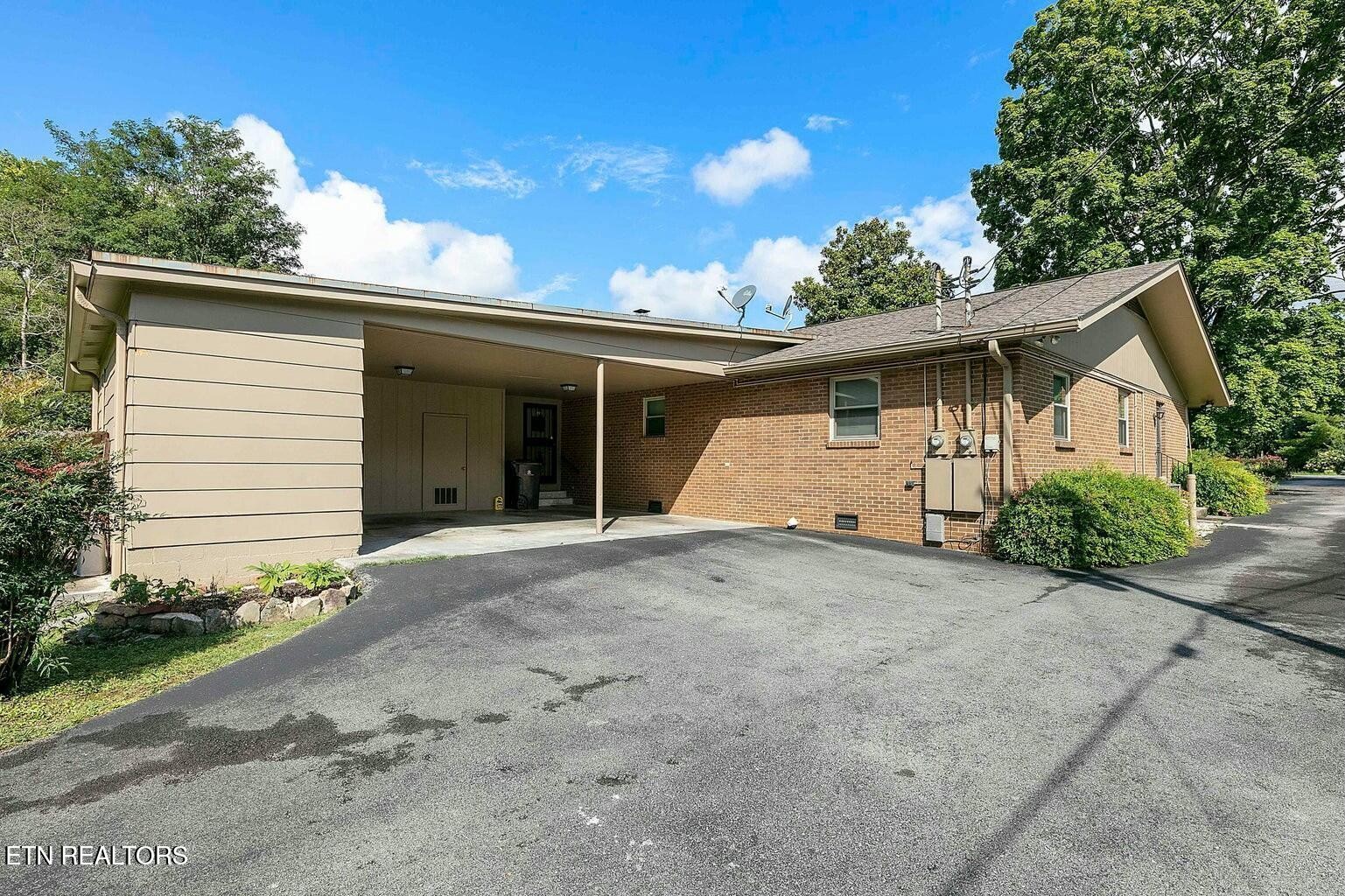 714 Broome Road Northwest, Unit B Knoxville, TN 37909 - Photo 10 of 10 a view of a white house with a yard and garage