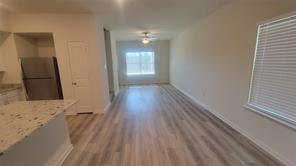315 Marsh Lane Princeton, TX 75407 - Photo 17 of 20 a view of a hallway with wooden floor and a bathroom
