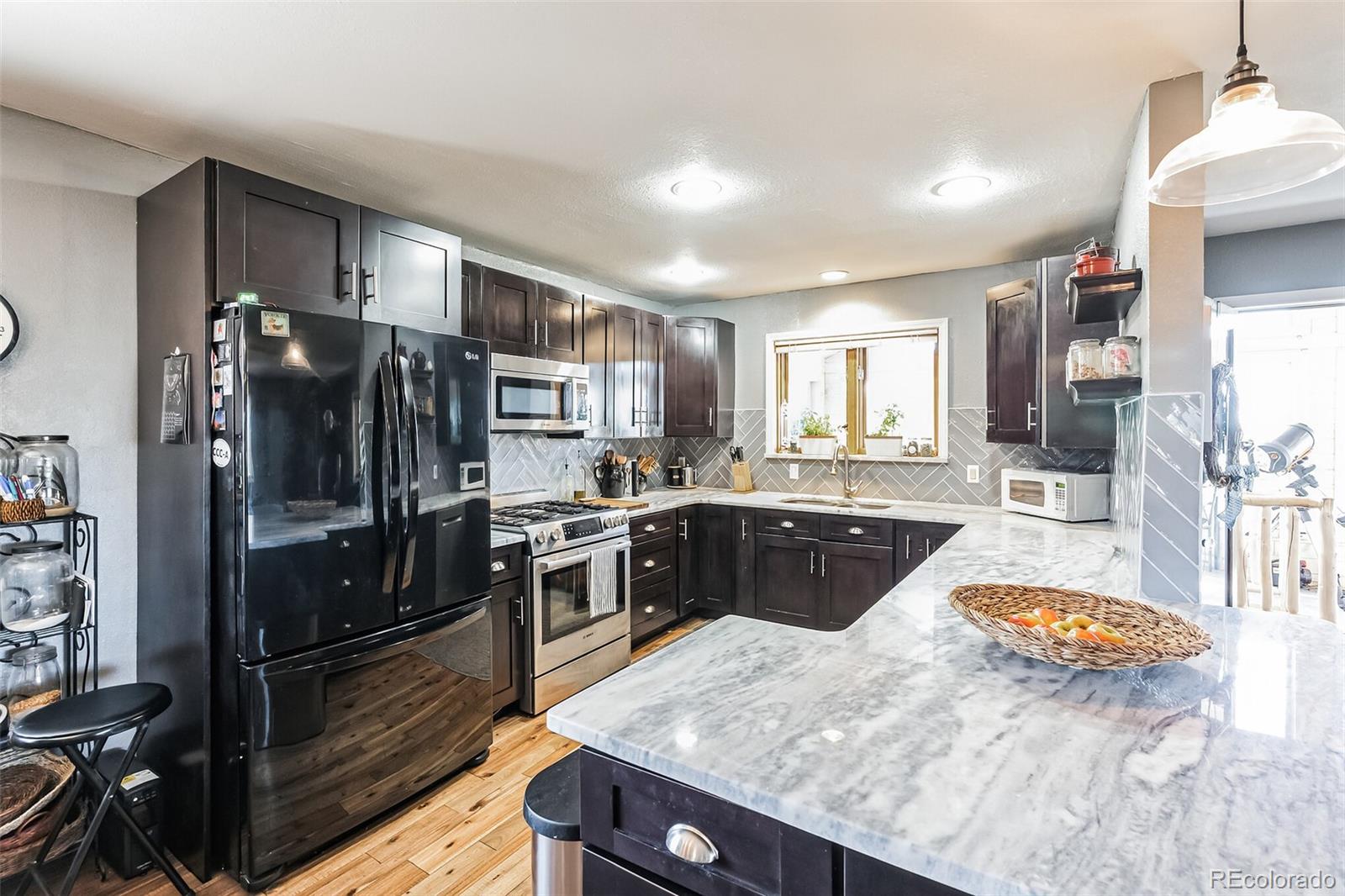 7882 Combs Road Fort Garland, CO 81133 - Photo 11 of 43 a large kitchen with a large counter top stainless steel appliances and cabinets