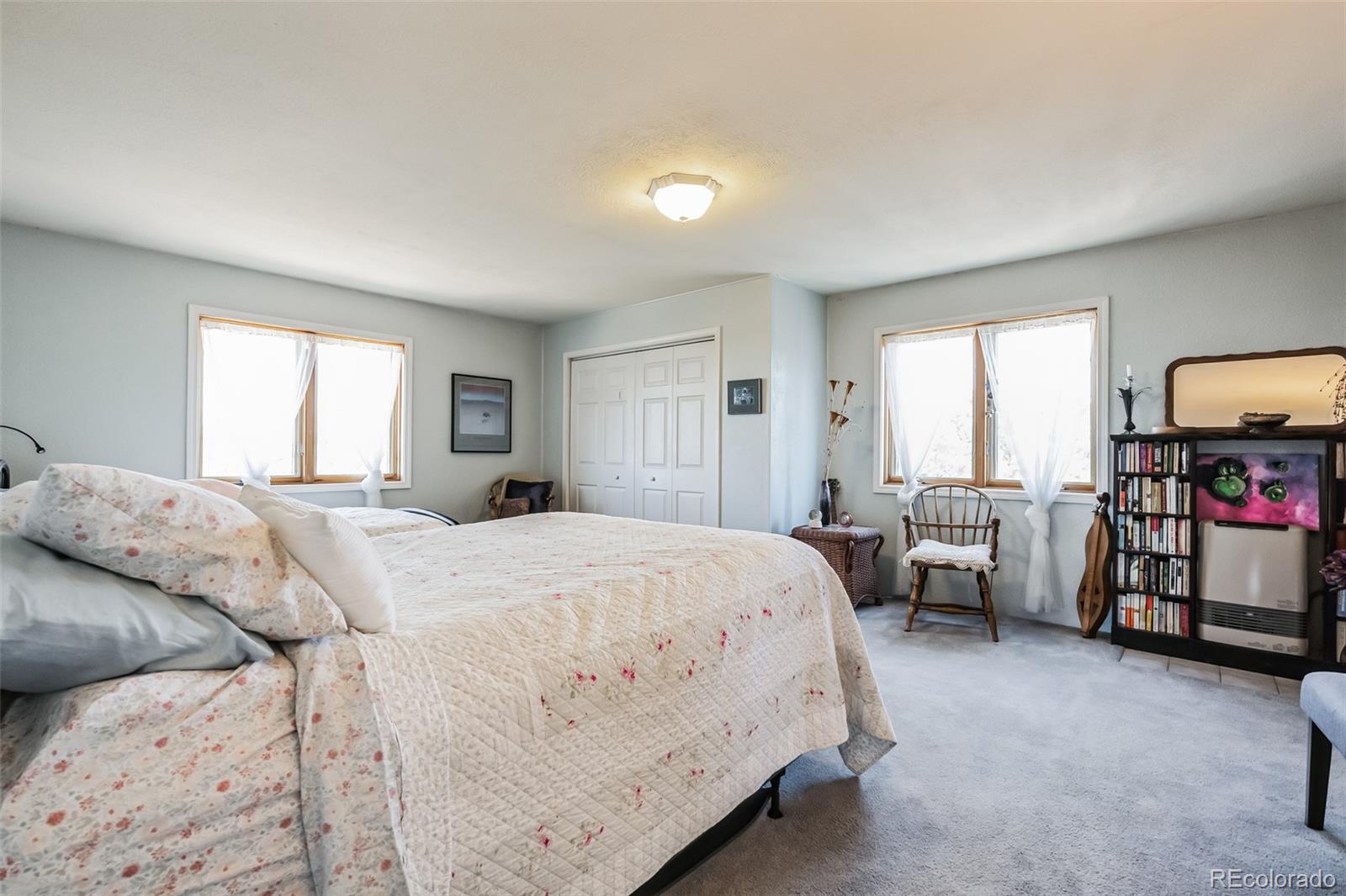 7882 Combs Road Fort Garland, CO 81133 - Photo 13 of 43 a bedroom with a bed and a flat tv screen on the dresser