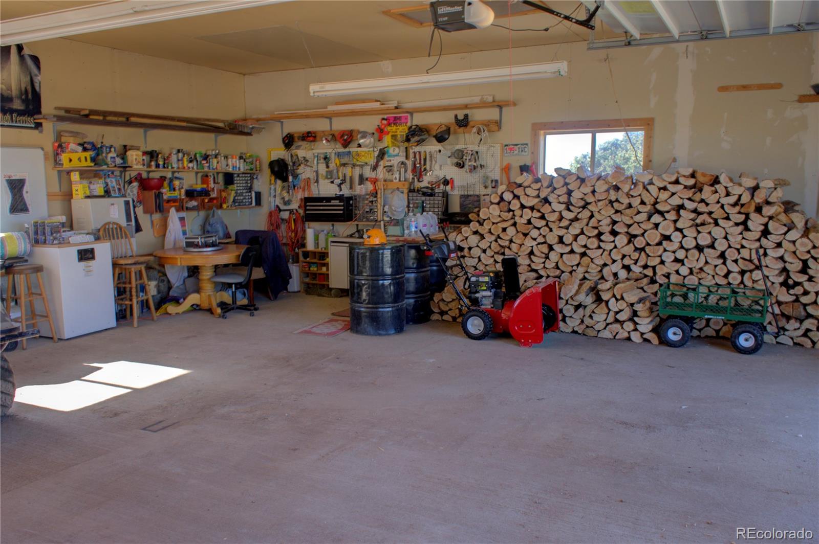 7882 Combs Road Fort Garland, CO 81133 - Photo 34 of 43 a view of a garage with a bike and storage