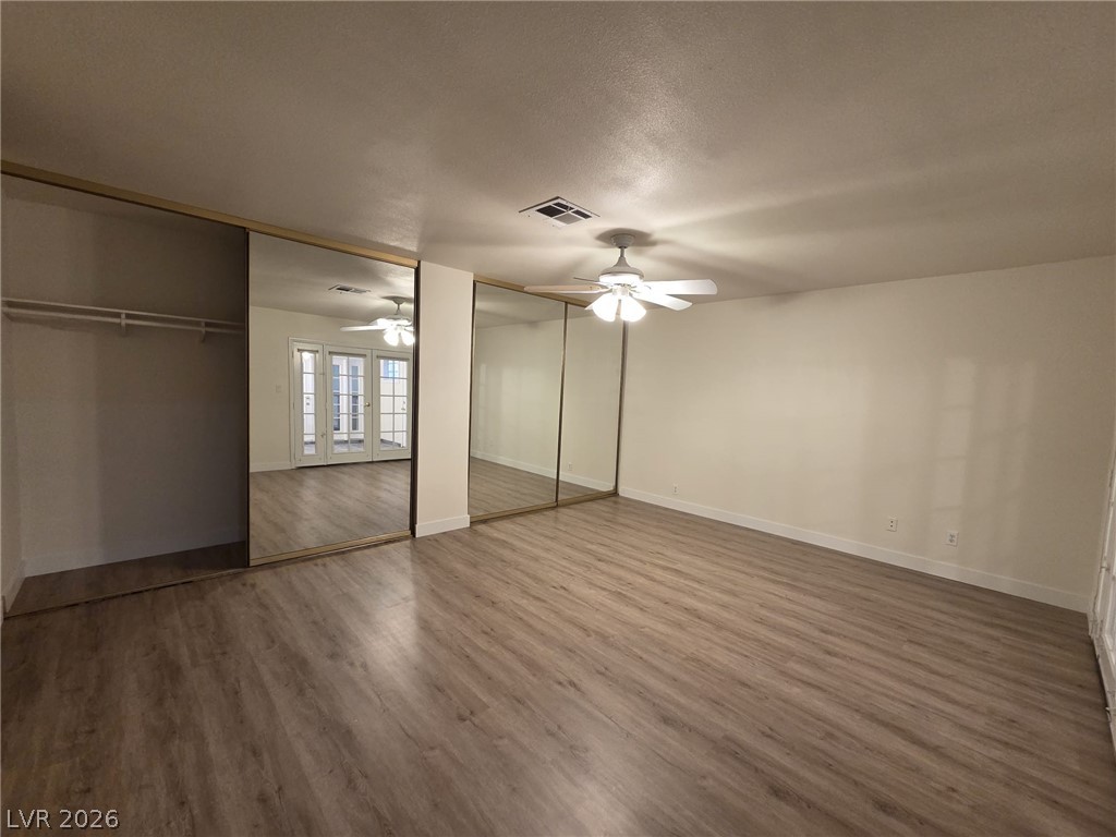 3317 Racquet Street Las Vegas, NV 89121 - Photo 9 of 23 This bright room features durable laminate flooring and mirrored closet doors.