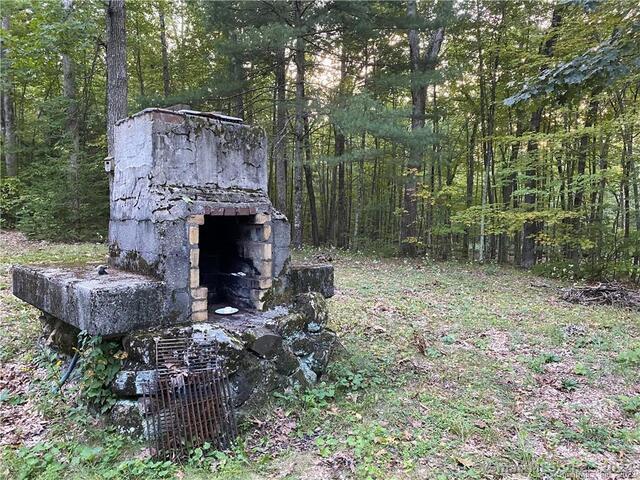 19 Potter Road Stafford, CT 06076 - Photo 7 of 18 a backyard of a house with fireplace table and chairs