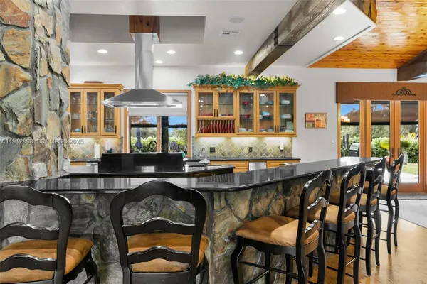 a dining room with furniture a chandelier and window