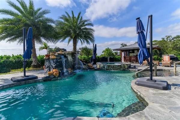 a view of a fountain in front of a house