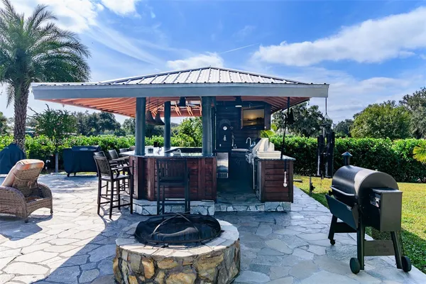 a view of a patio with couches and a fire pit