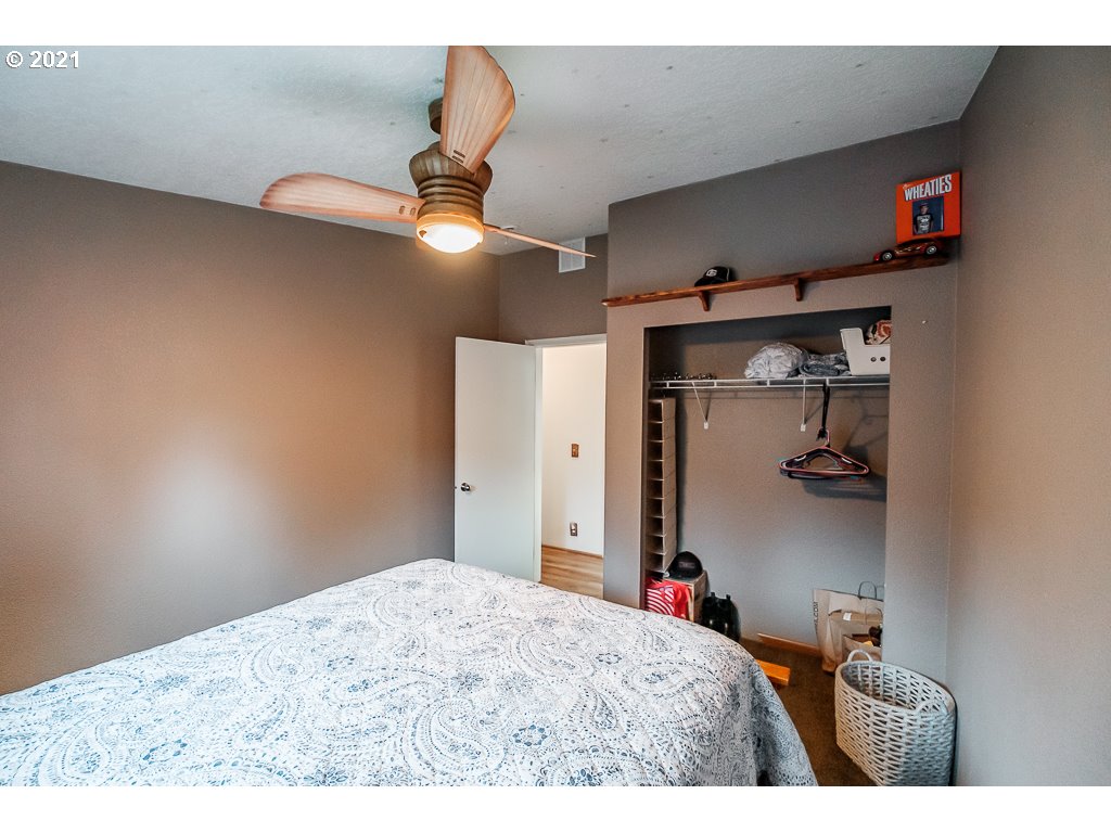11035 Winstanley Lyons Or 97358 Lyons, OR 97358 - Photo 17 of 31 a bedroom with a bed and a chandelier