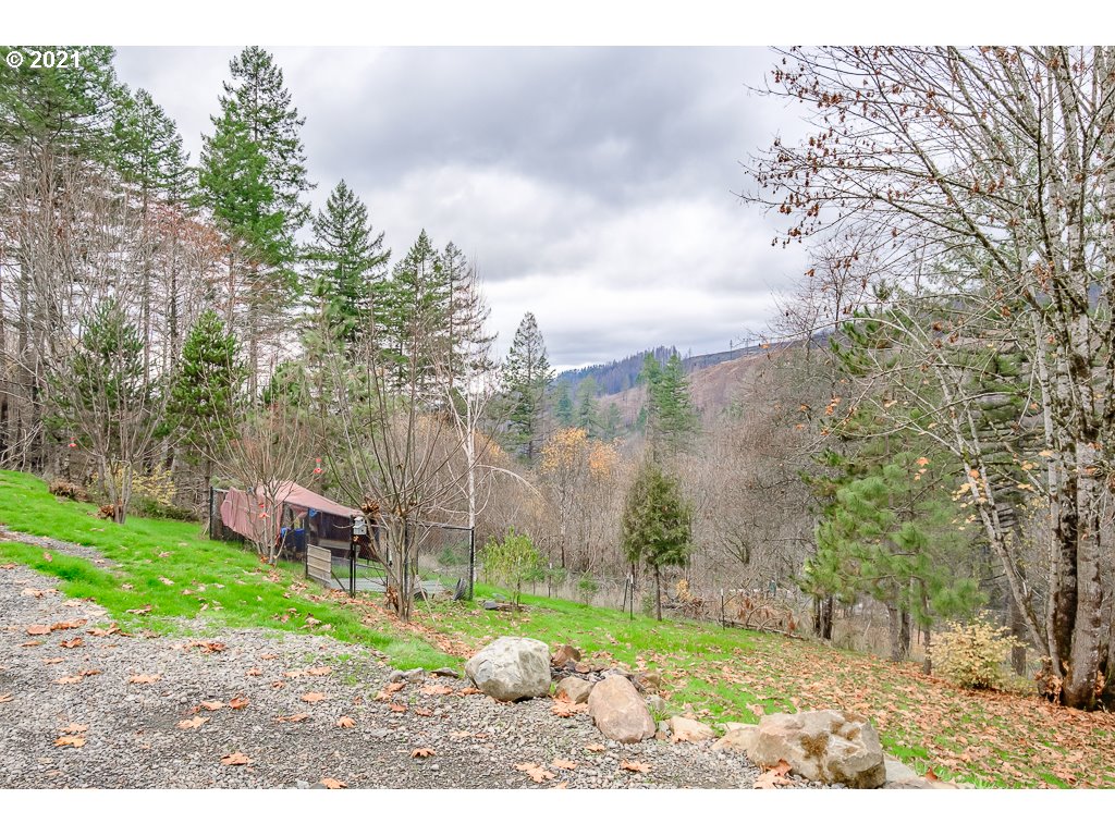 11035 Winstanley Lyons Or 97358 Lyons, OR 97358 - Photo 31 of 31 a backyard of a house with a garden and outdoor seating