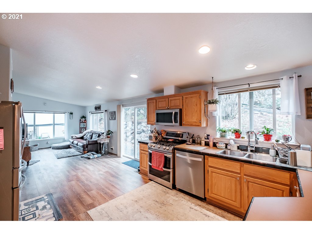 11035 Winstanley Lyons Or 97358 Lyons, OR 97358 - Photo 10 of 31 a kitchen with stainless steel appliances a stove a sink dishwasher a oven with white cabinets and wooden floor