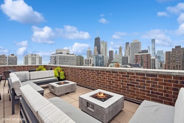 a view of roof deck with seating space and barbeque oven