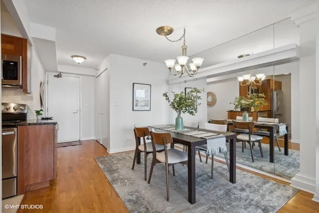 a view of a dining room with furniture and chandelier