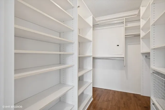 a view of walk in closet with empty racks