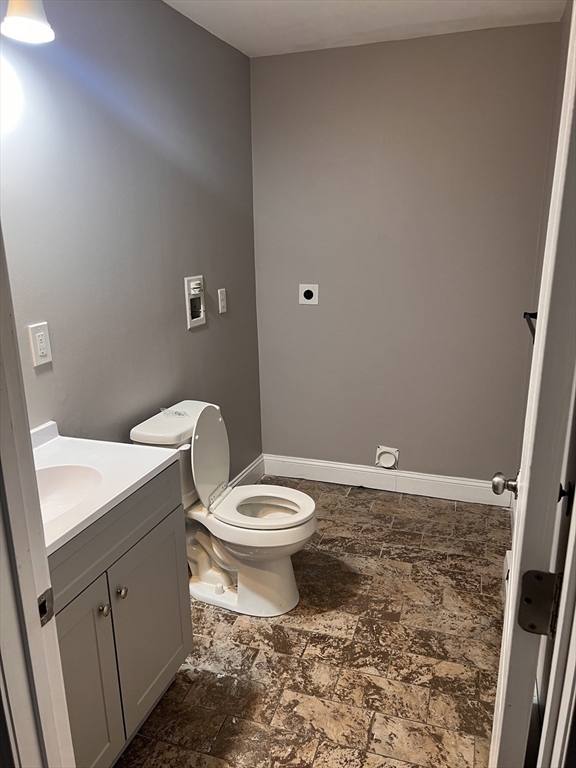 582 Centre Street, Unit 2 Brockton, MA 02302 - Photo 3 of 8 a bathroom with a toilet a sink and a mirror