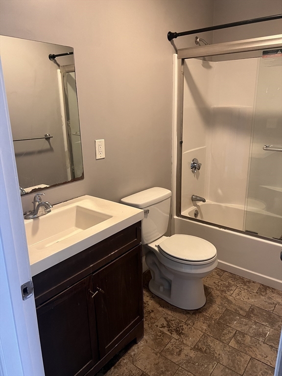 582 Centre Street, Unit 2 Brockton, MA 02302 - Photo 5 of 8 a bathroom with a granite countertop sink toilet and shower