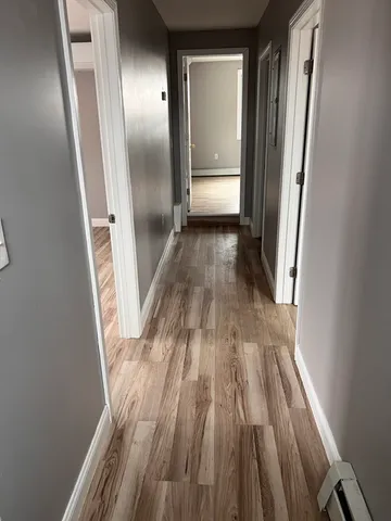 a view of gallery with wooden floor