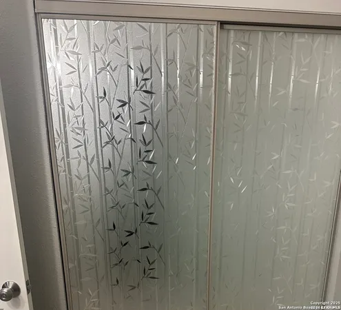 a bathroom with a shower and a curtain