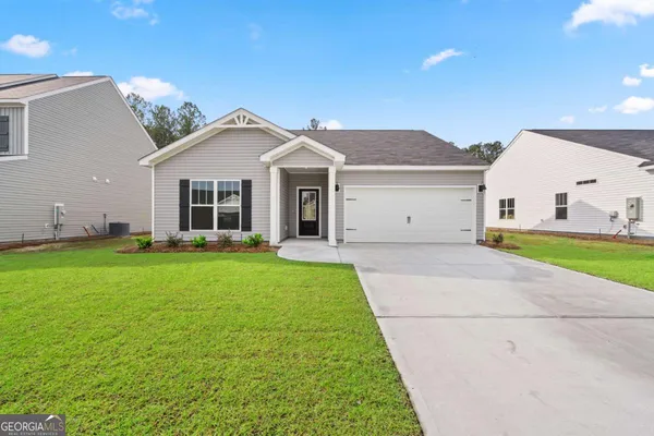 a view of a house with a backyard