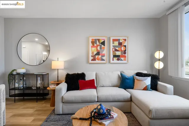 a living room with furniture a mirror and a large mirror