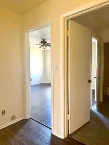 a view of a hallway with wooden floor