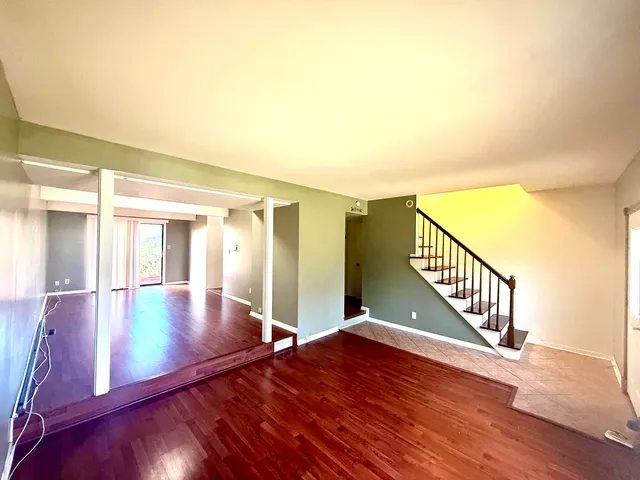 a view of an entryway with wooden floor