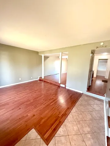 a view of a room with wooden floor