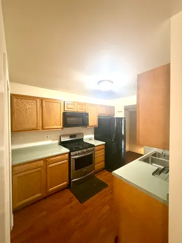 a kitchen with a stove a sink and a refrigerator