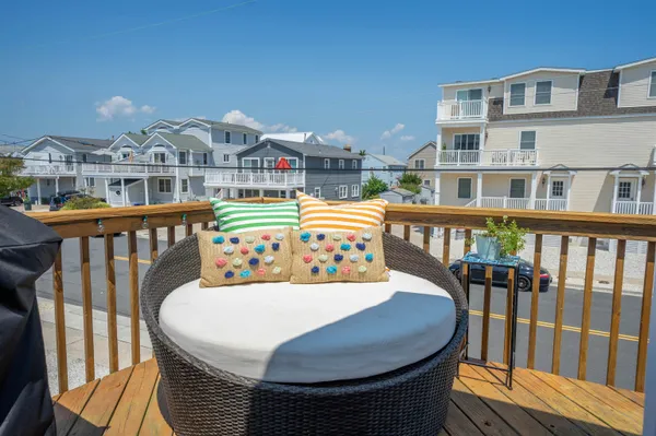 a view of a balcony dining area with furniture