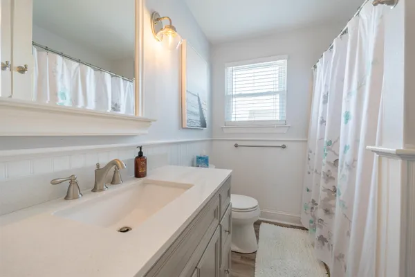 a bathroom with a sink toilet and shower