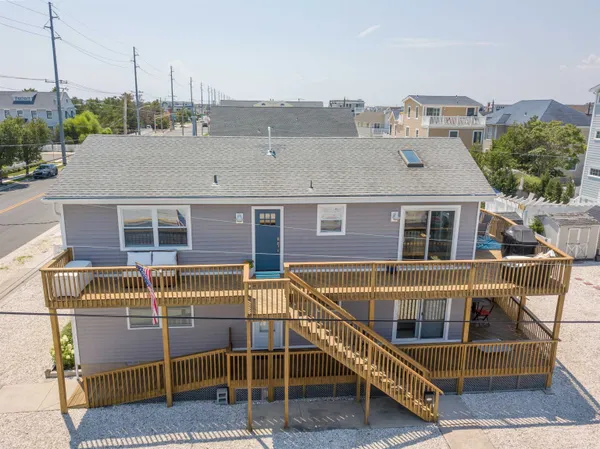 a view of house with roof deck and seating space