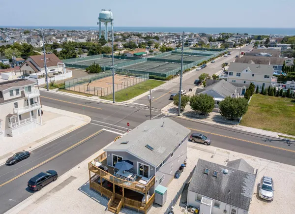 an aerial view of a house with a swimming pool and outdoor seating