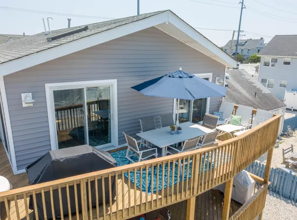 a balcony with furniture and umbrella