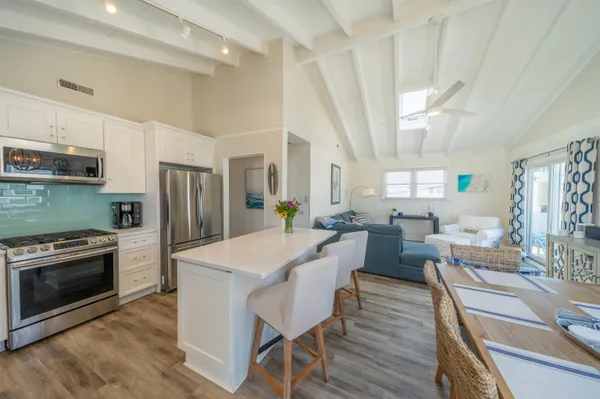 a large kitchen with a table and chairs