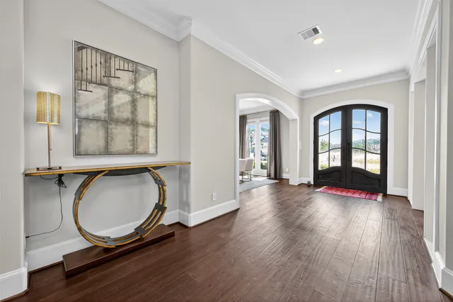 a view of a livingroom with wooden floor and stairs