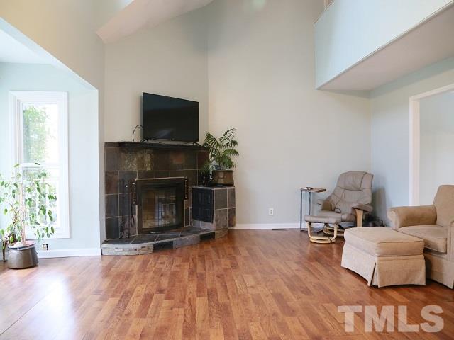 2300 Rolesville Road Wake Forest, NC 27587 - Photo 5 of 24 a living room with furniture a flat screen tv and a fireplace